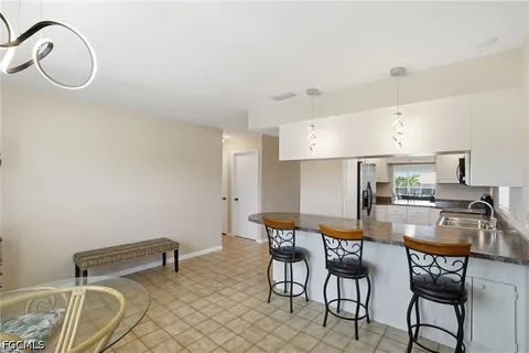 a kitchen with stainless steel appliances kitchen island granite countertop a sink and cabinets