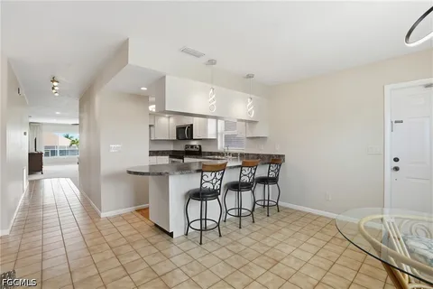 a kitchen with a sink a stove and cabinets