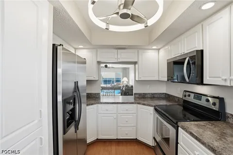a kitchen with a sink stove and refrigerator