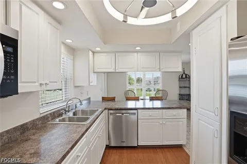 a kitchen with a sink stove and microwave