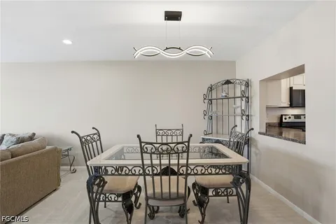a dining room with furniture and wooden floor