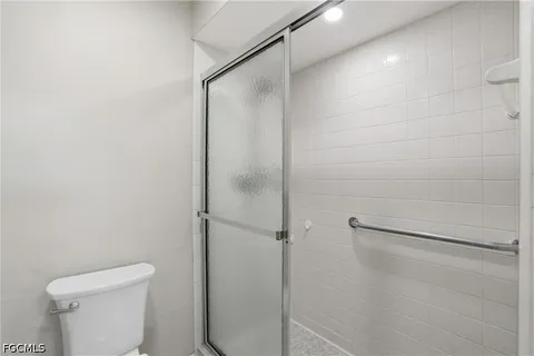 a en suite bathroom with a granite countertop sink and a mirror