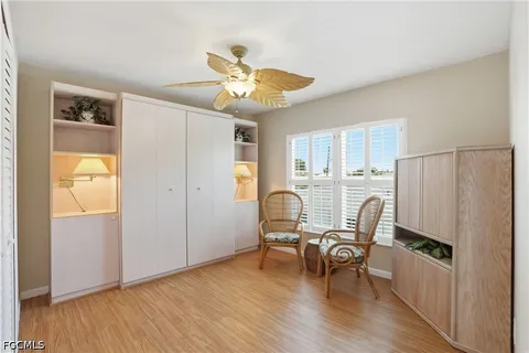 a room with wooden floor and windows