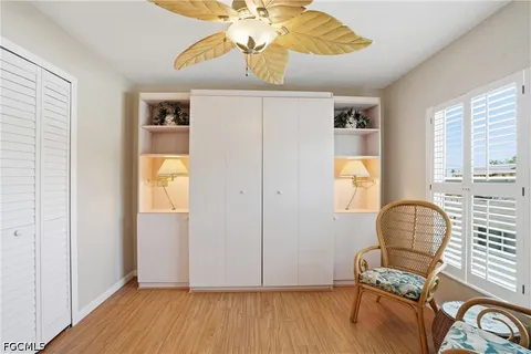a view of a workspace with furniture and chandelier