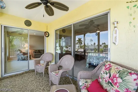 a living room with furniture a window and a chandelier
