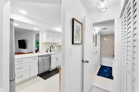 a spacious bathroom with a double vanity sink a mirror a shower and a bathtub