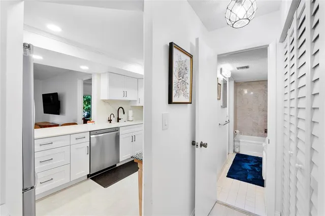 a spacious bathroom with a double vanity sink a mirror a shower and a bathtub