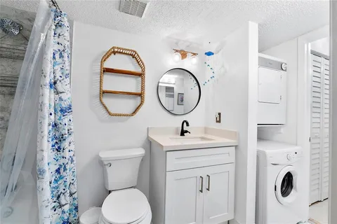 a bathroom with a toilet sink vanity and mirror