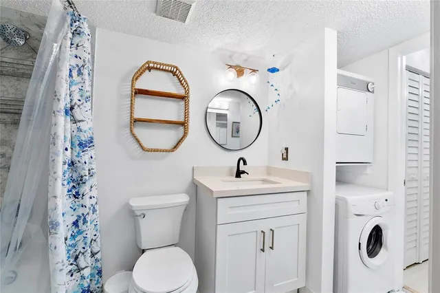 a bathroom with a toilet sink vanity and mirror