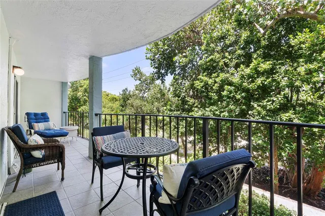a view of a balcony with chairs and a table