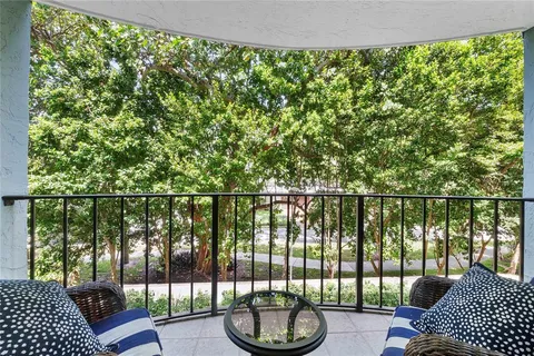 a view of a balcony with lake view and a floor to ceiling window