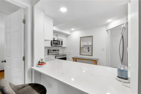 a kitchen with stainless steel appliances a refrigerator and a sink