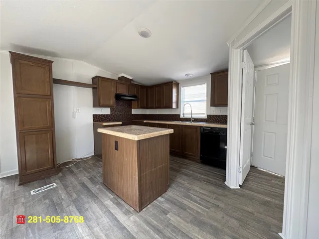 a kitchen with a sink stove and refrigerator