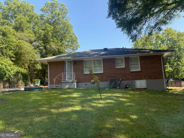 a backyard of a house with table and chairs