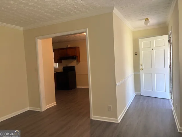 a view of a hallway with wooden floor and closet