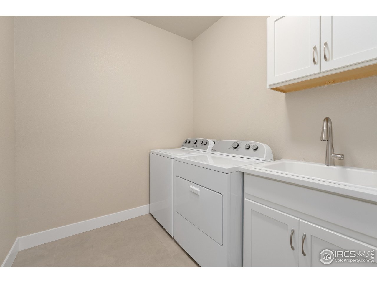 6228 Vernazza Way, Unit 3 Windsor, CO 80550 - Photo 25 of 41 Laundry room with built in cabinets and sink