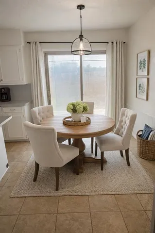 a dining room with furniture and window