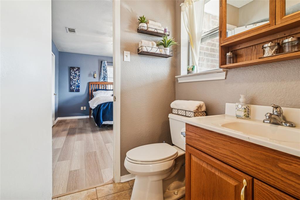 903 Houston Street Anna, TX 75409 - Photo 19 of 27 a bathroom with a sink a toilet and shower