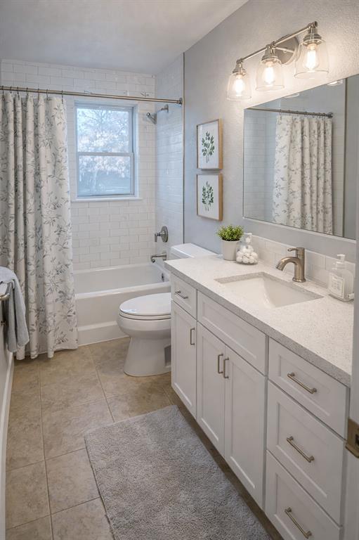 903 Houston Street Anna, TX 75409 - Photo 21 of 27 a spacious bathroom with a double vanity sink toilet and a bathtub