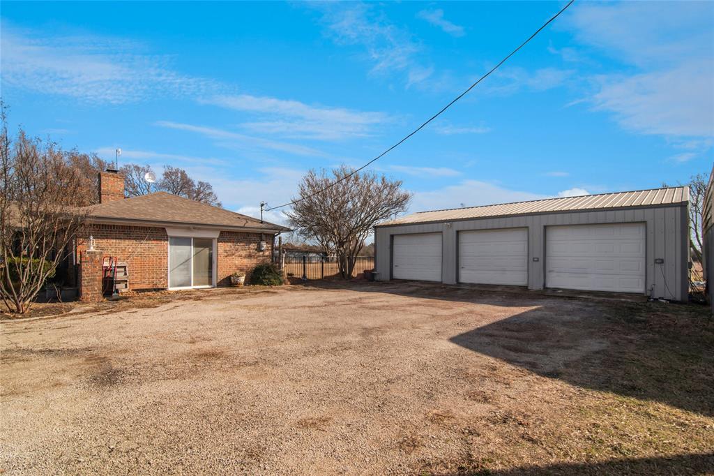 903 Houston Street Anna, TX 75409 - Photo 26 of 27 a front view of a house with a yard and garage