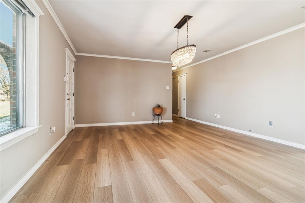 903 Houston Street Anna, TX 75409 - Photo 3 of 27 a view of empty room with wooden floor and fan