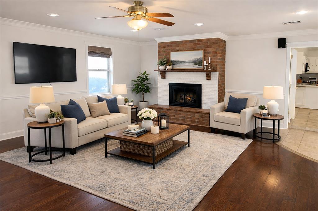 903 Houston Street Anna, TX 75409 - Photo 9 of 27 a living room with furniture a flat screen tv and a fireplace
