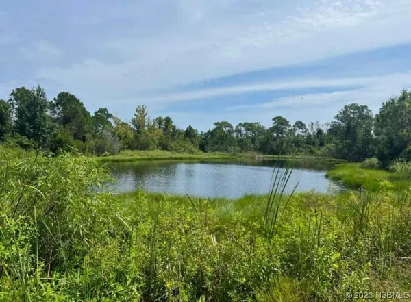 a view of a lake with houses in the back