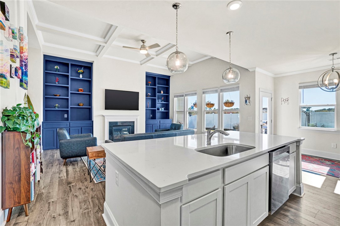 142 Juniper Hill Drive Easley, SC 29642 - Photo 17 of 47 This bright, open concept living space features a kitchen island and cozy fireplace.