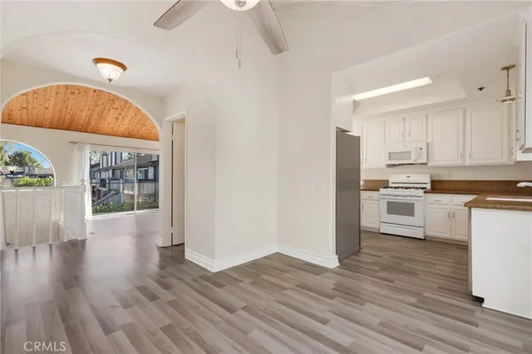 a view of a kitchen with wooden floor and a window