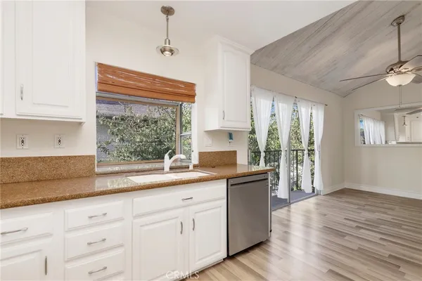 a kitchen with a sink window and cabinets