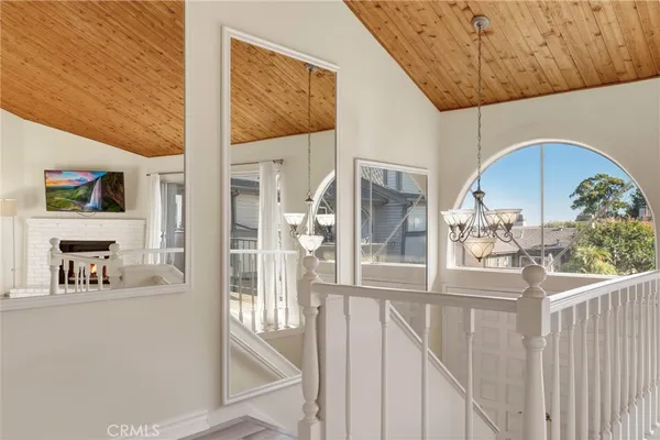 a view of a hallway with a dining table & chairs