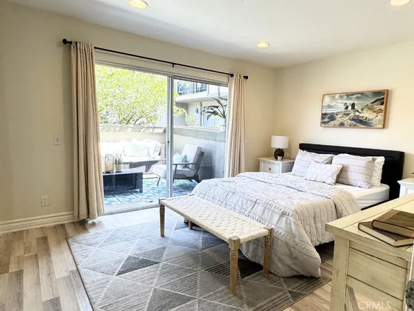 a spacious bedroom with a bed and a large window