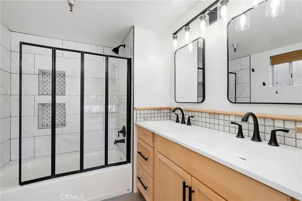 a bathroom with a double vanity sink mirror and