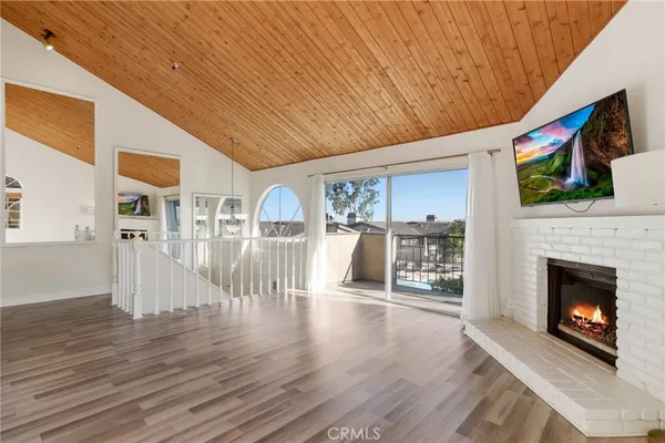 a living room with furniture wooden floor and a fireplace
