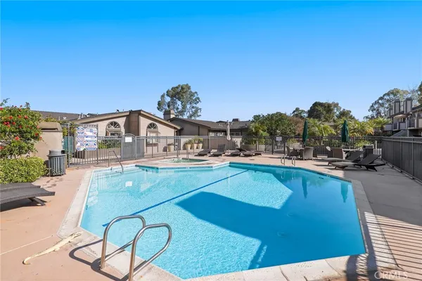 a view of a swimming pool and lounge chair