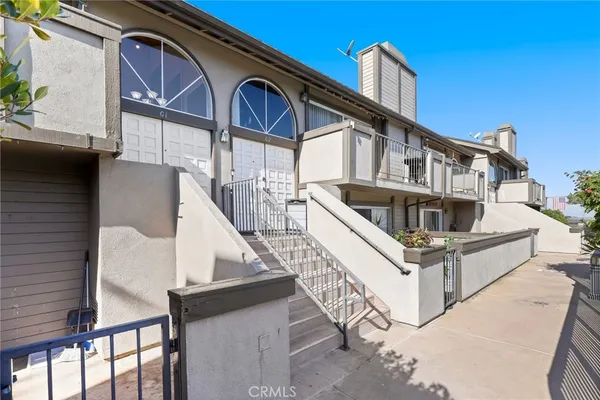 a view of a house with a small yard and deck