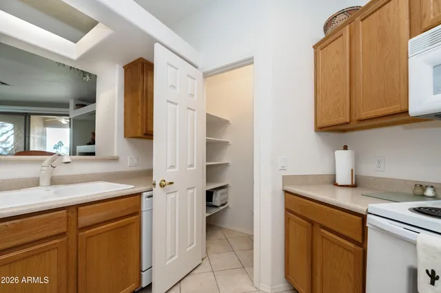 a kitchen with stainless steel appliances granite countertop a sink and a refrigerator