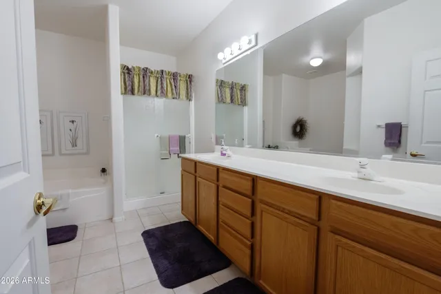 a bathroom with a double vanity sink and a mirror