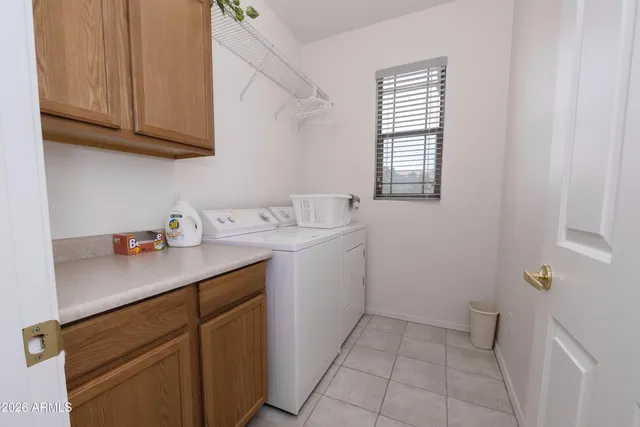 a utility room with sink dryer and washer