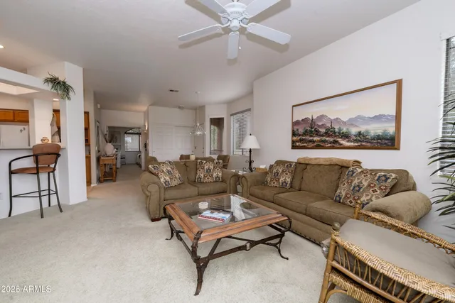 a living room with furniture a table and a painting