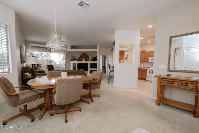 a view of a dining room with furniture and chandelier