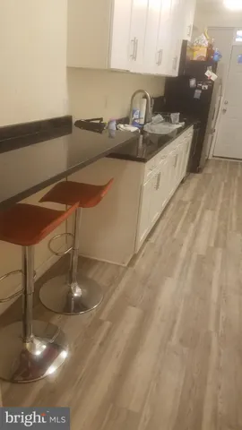 a kitchen with a sink a stove and cabinets