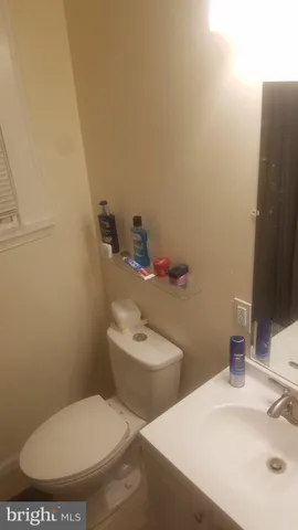 a white toilet sitting next to a bathroom sink