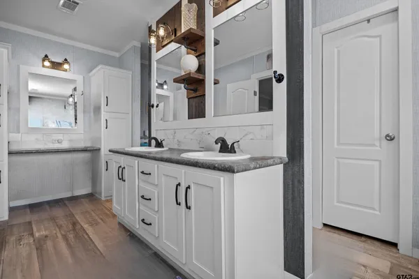 a spacious bathroom with a granite countertop bathtub and window