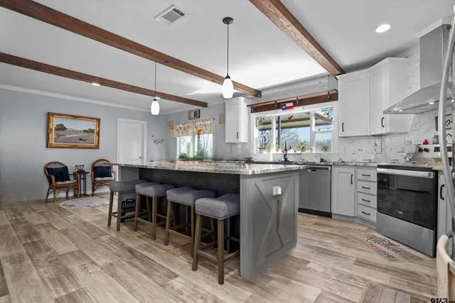 a kitchen with a sink stove and cabinets
