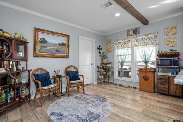 a spacious bedroom with a bed and a chandelier