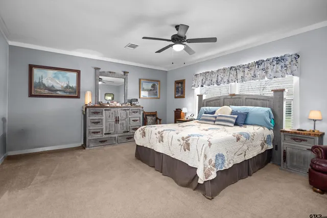 a bedroom with a bed and a television