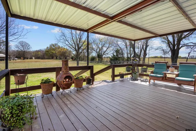 a view of a deck with wooden floor and outdoor seating