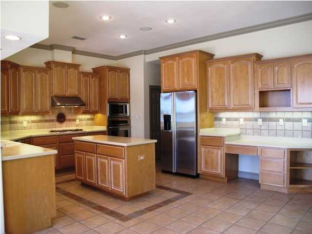4491 Woodbridge Road Niceville, FL 32578 - Photo 10 of 17 a kitchen with stainless steel appliances granite countertop a stove top oven a refrigerator and a sink