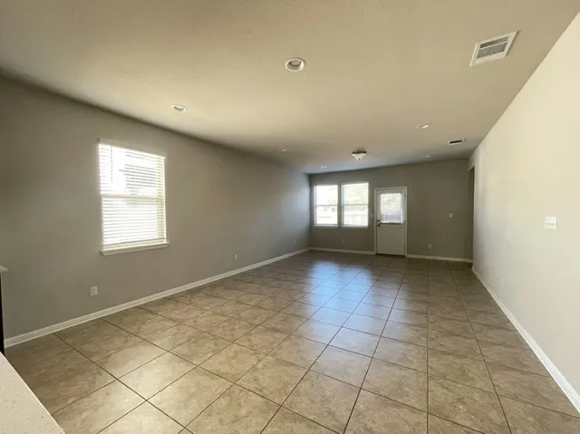 a kitchen with stainless steel appliances granite countertop a refrigerator a sink a stove a microwave and island